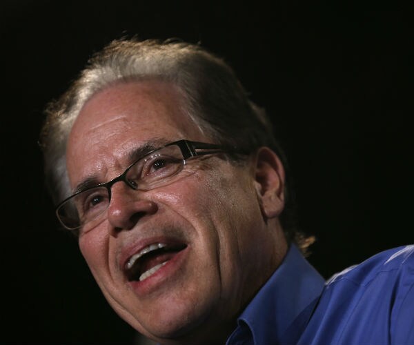Sen. Mike Braun in a blue button down shirt speaks to an audience in Indiana.