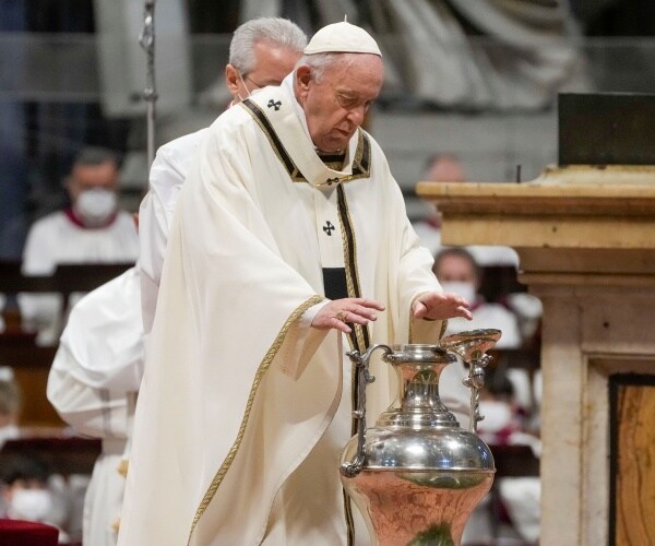 pope francis blesses chrism oil contained in a jar