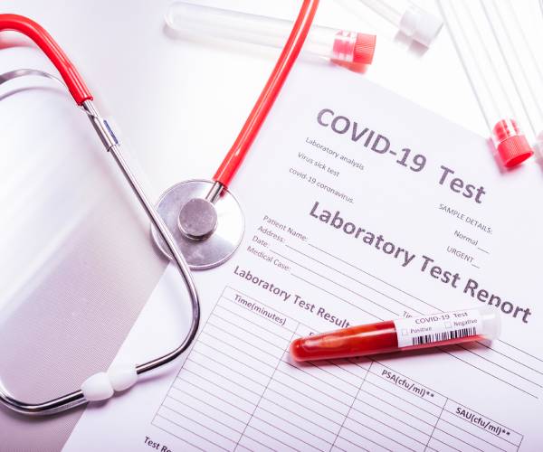 a covid test with a blood sample and a stethoscope