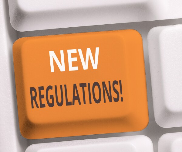 a computer buttun reading new regulations