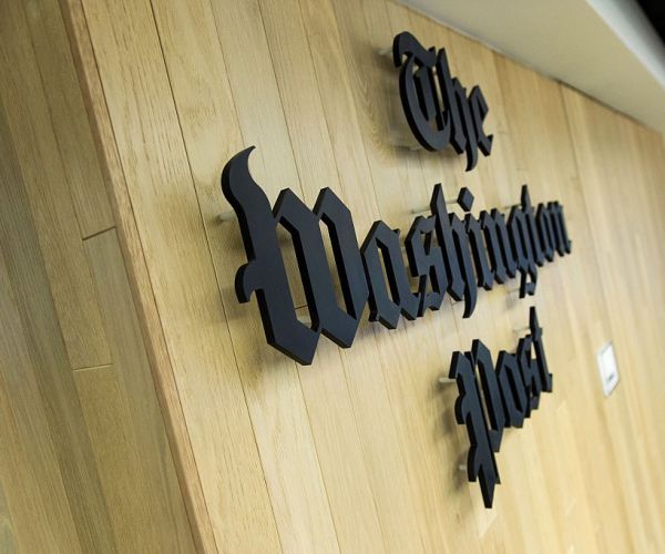 a man walks through the newsroom in the washington post's new building in 2016.