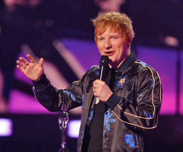 ed sheeran performs at a concert
