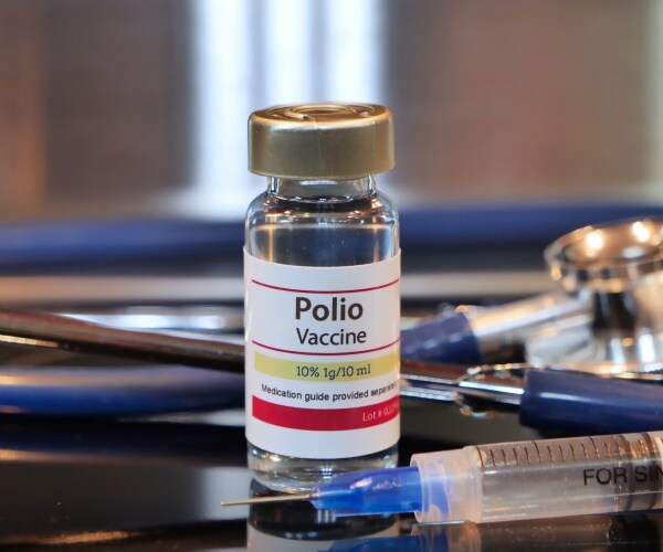vial of polio vaccine, syringe, stethoscope