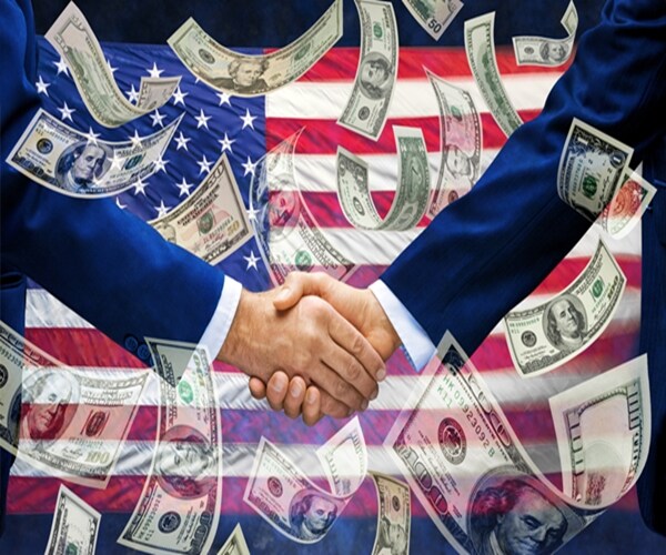 a pair of businessmen shaking hands with an American flag and money falling down around them 