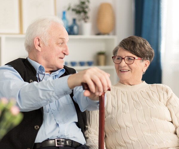 two senior citizens smiling at each other