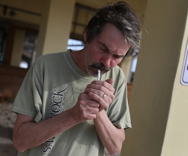 a man lights a cigarette