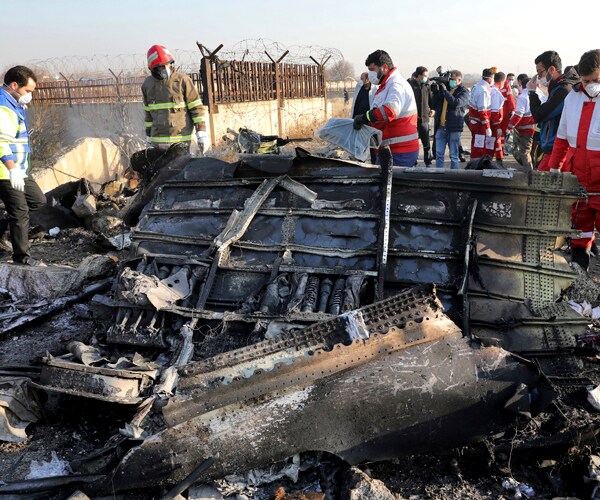 rescue workers at the scene of a january 8 plane crash in tehran in which iran shot down a passenger jetliner