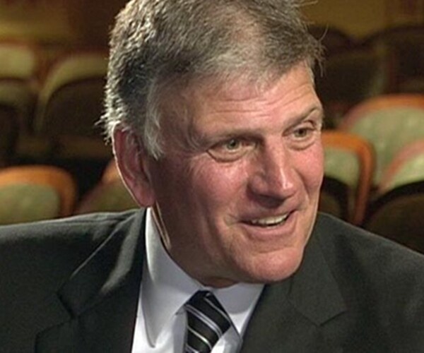 reverend franklin graham turns his head to the left and smiles