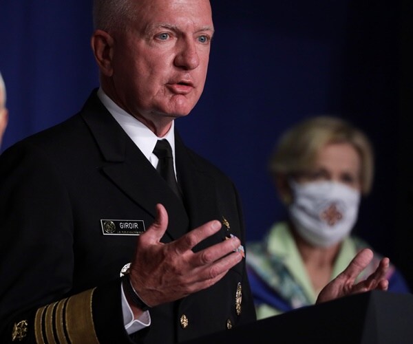 adm. brett giroir, wearing military dress, speaks standing in front of mike pence and deborah birx