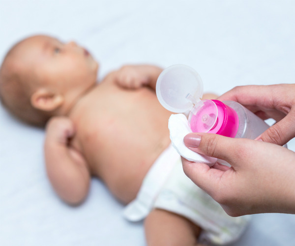 Applying baby powder to a newborn