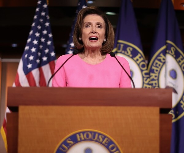 nancy peloso speaks to the press at a new conference about stimulus legislation