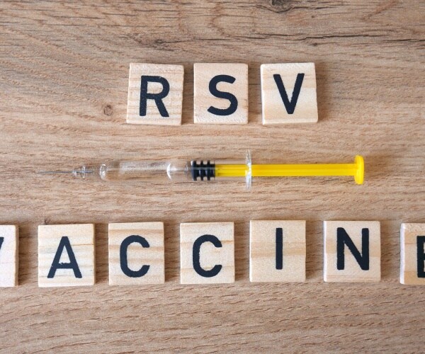 syringe and 'RSV vaccine' spelled out in wood blocks