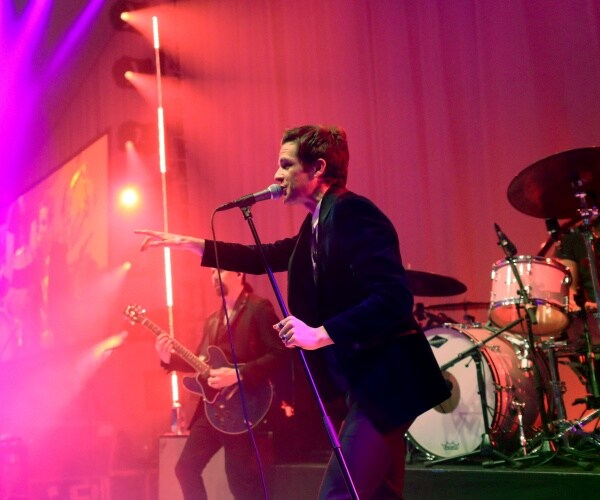 brandon flowers performs on stage