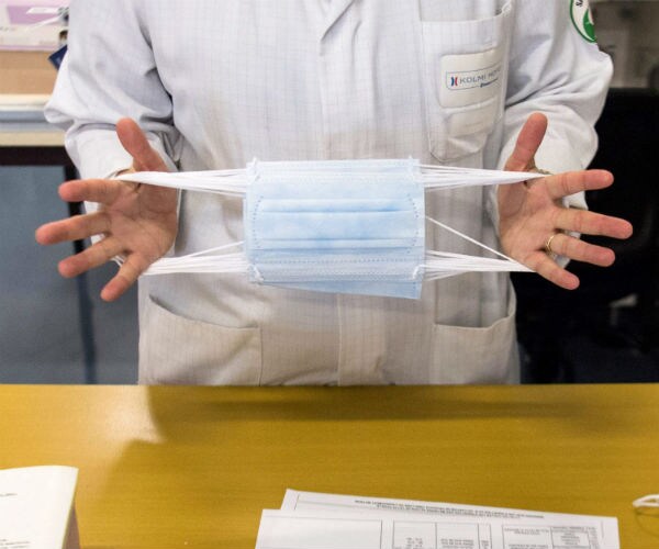 a person holds surgical masks