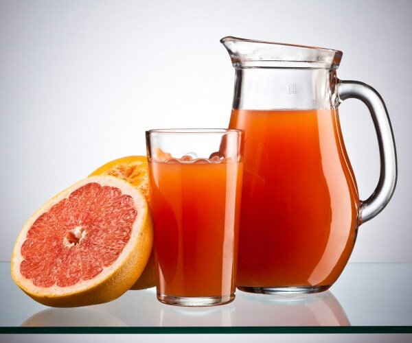 grapefruit and a pitcher of grapefruit juice