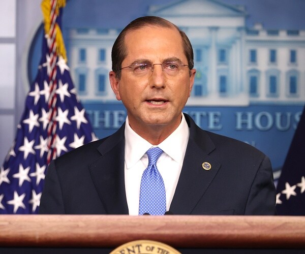 alex azar speaks into microphone