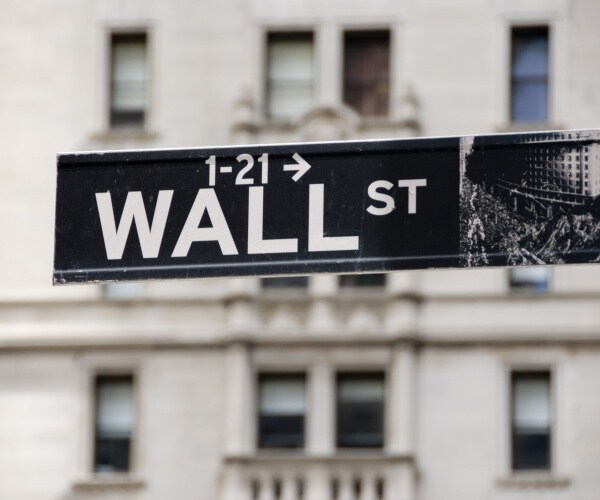 wall street sign is shown in the finance district of nyc