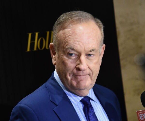 political commentator bill o'reilly looks to his right while listening to a question