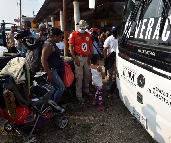 Migrants heading in a caravan to the U.S. board a bus.