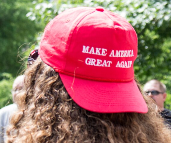 person wearing a red maga hat