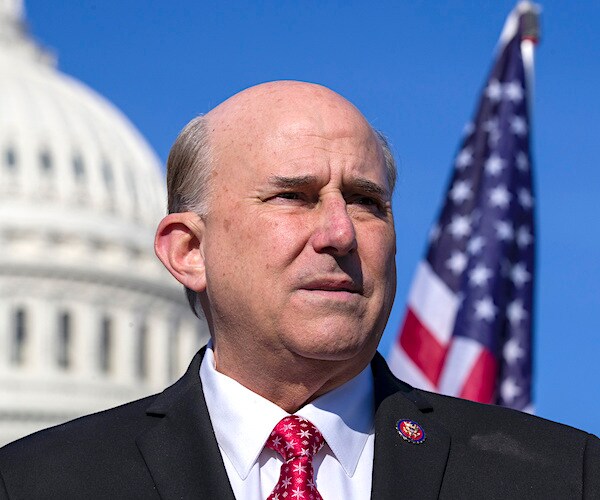 louie gohmert delivers a news conference outdoors with an american flag over his left shoulder