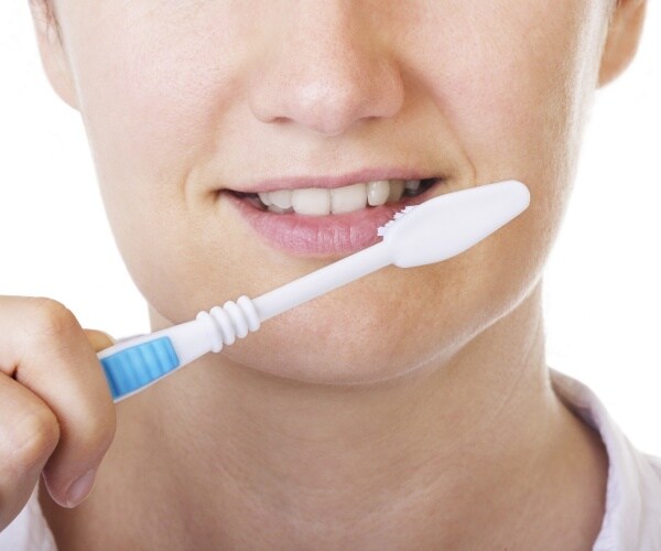 close-up of person brushing teeth