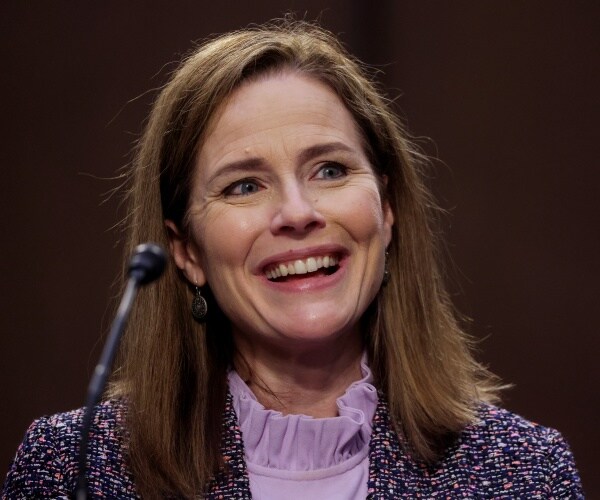 barrett in a purple multicolor coat and lavender top smiling