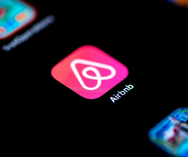 the logo of the online lodging service airbnb displayed on a smartphone