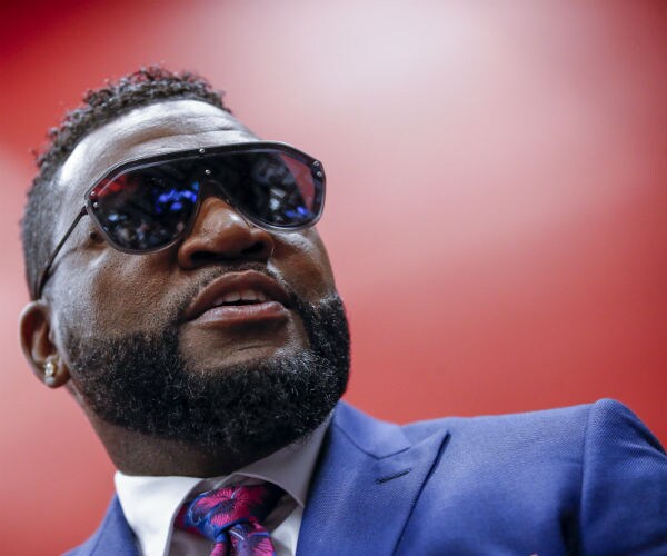 former red sox star david ortiz is shown wearing sunglasses with blue suit, dress shirt and tie