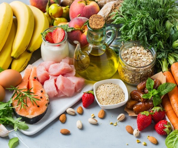 foods on the Mediterranean diet including leafy vegetables, fish, olive oil, nuts, seeds