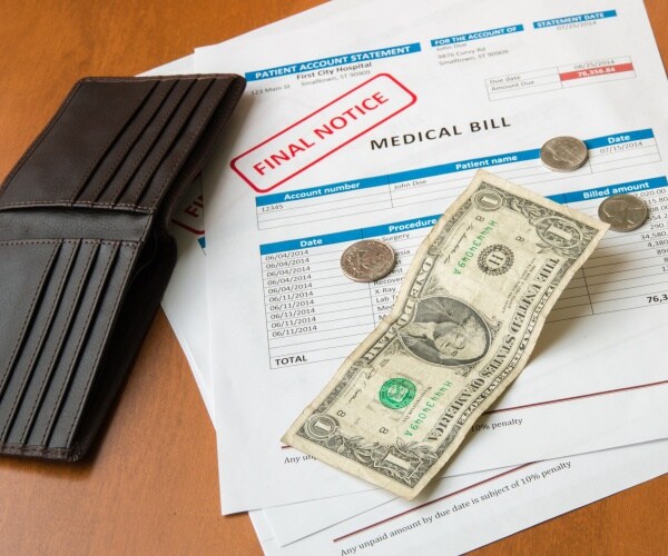 medical bill, dollar bills, empty wallet signifying medical debt