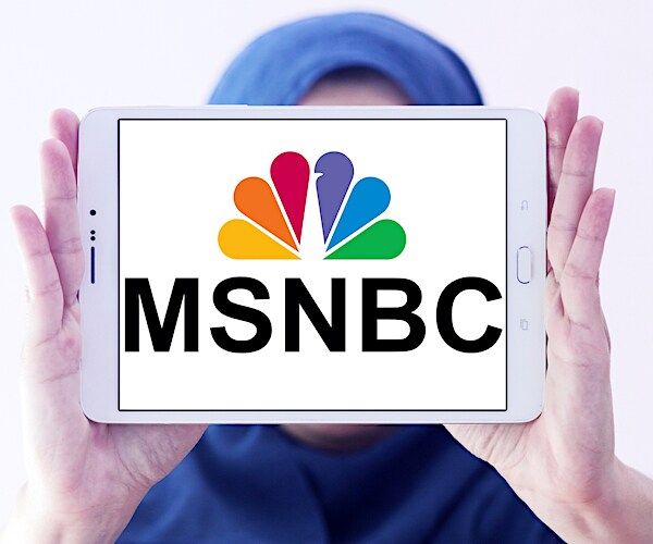 a tablet shows the em es en bee see logo being held up by a faceless muslim woman