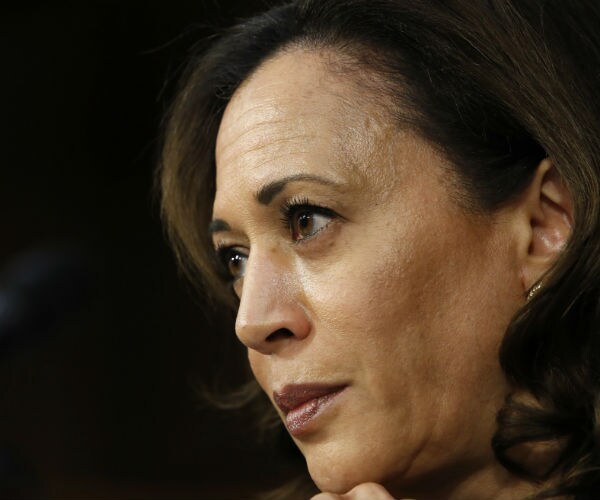 california democratic senator kamala harris holds her chin in her left hand as she listens to senate testimony