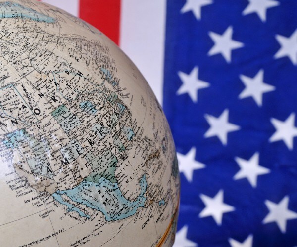 a globe with the united states in focus with an american flag in the background
