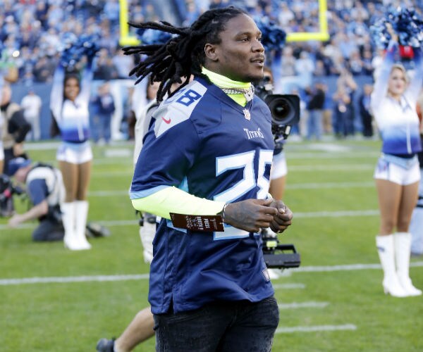former tennessee titans running back chris johnson runs onto the field before an nfl game