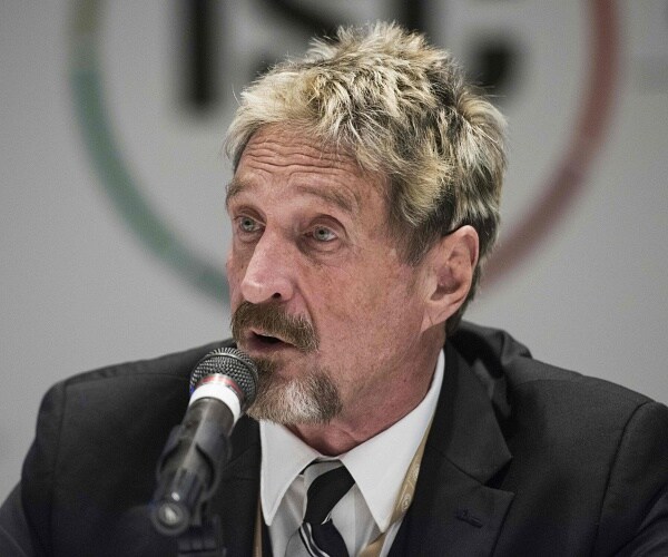 john mcafee speaks into mic