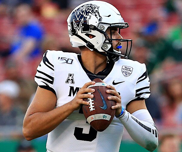the memphis tigers helmet on a right-handed quarterback who is looking downfield for a target