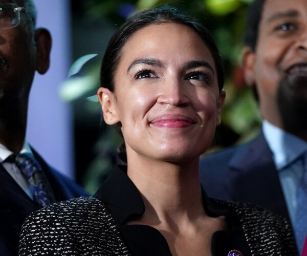 Alexandria Ocasio-Cortez poses for a picture 