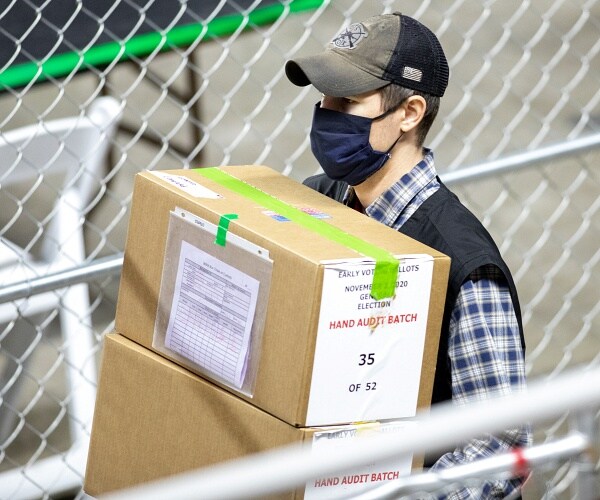 worker carries boxes