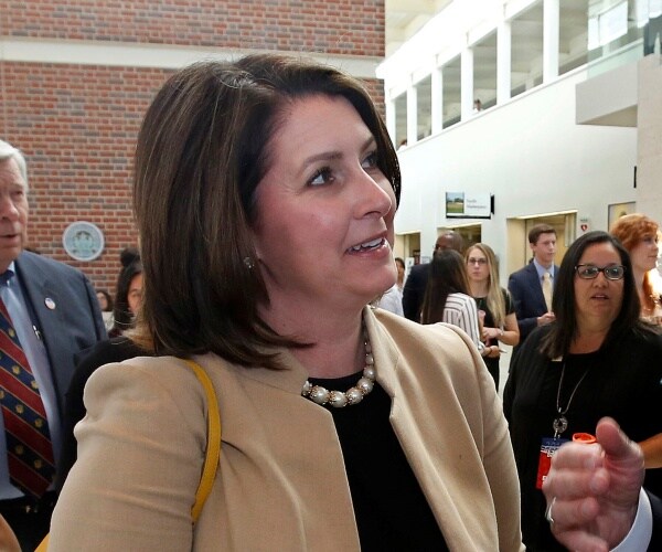 Kristina Lawson speaking to a man.