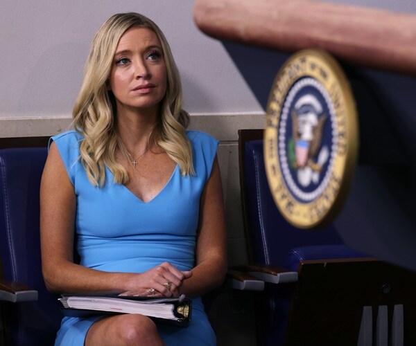 kayleigh mcenany waits while the president speaks at the briefing room