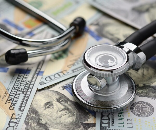 $100 bills and stethoscope