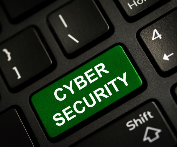 a keyboard is shown with the word cyber security on the return key, shown in white letters on a green background