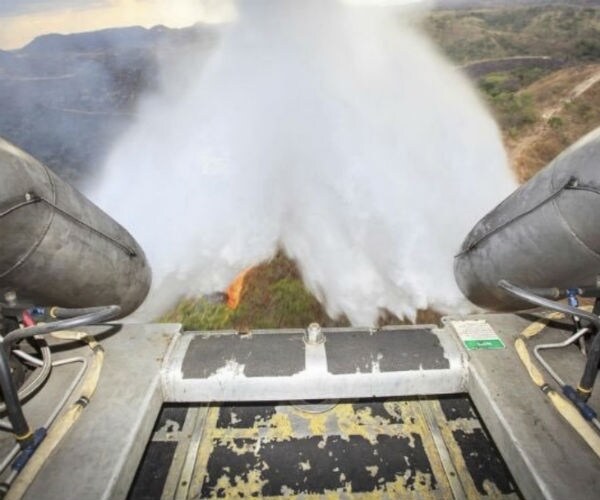 water being dumped from the back of a cargo plane