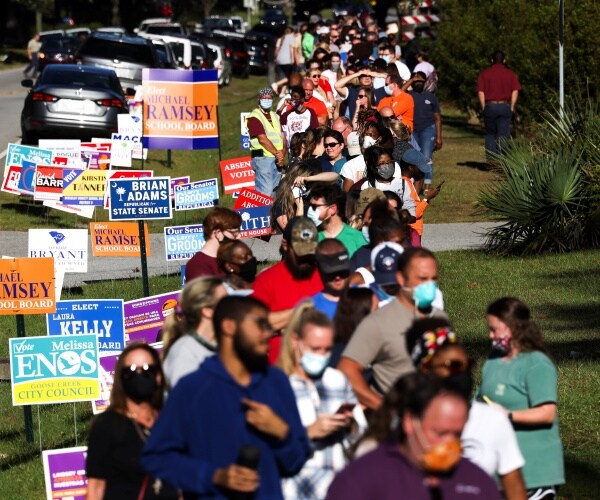 voters are lined up, some wearing masks, in south carolina