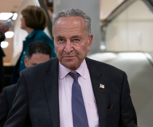 sen. chuck schumer gets off an escalator in the capitol