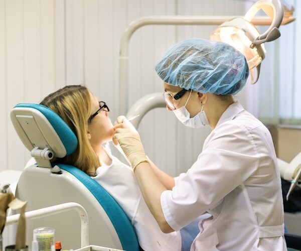 woman being examined by dentist
