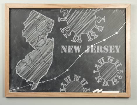 blackboard with image of new jersey and covid