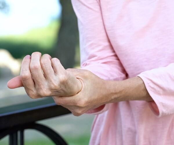 a woman suffering from arthritis