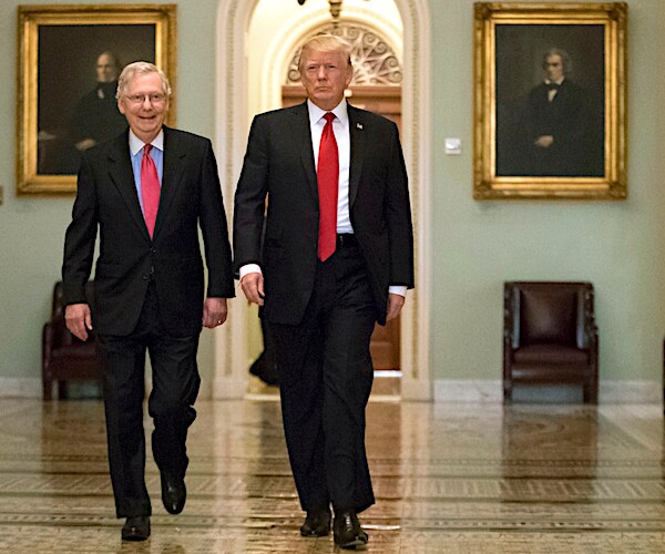 Senate Minority Leader Mitch McConnell, R-Ky., and President Donald Trump walk down the halls of congress